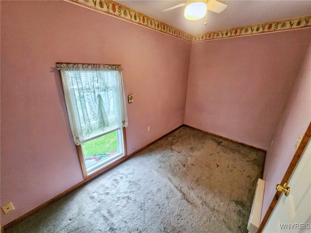 spare room with carpet flooring and ceiling fan