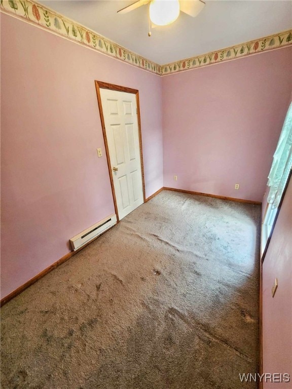 carpeted empty room with ceiling fan and baseboard heating