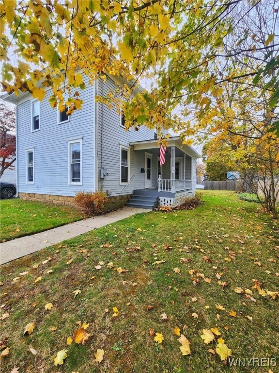 view of front of house featuring a front yard and covered porch