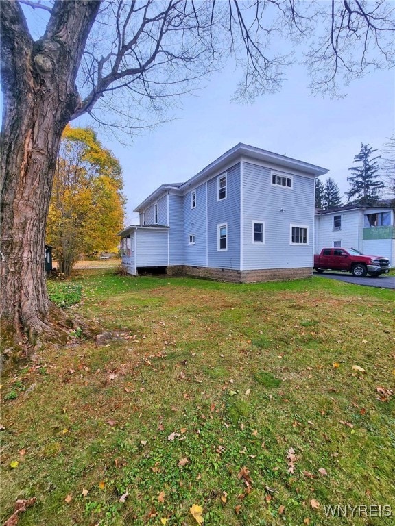 view of property exterior with a lawn