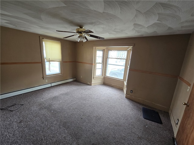 carpeted empty room featuring ceiling fan and a baseboard radiator