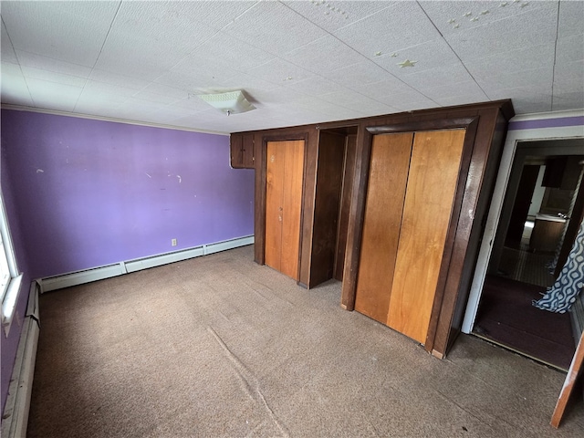 unfurnished bedroom featuring baseboard heating and carpet