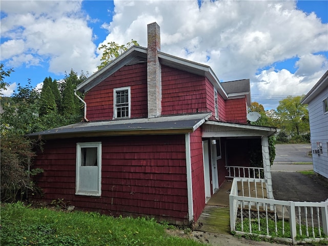 view of side of home with a porch