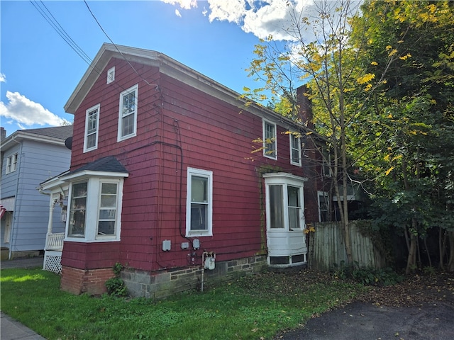 view of side of home with a yard