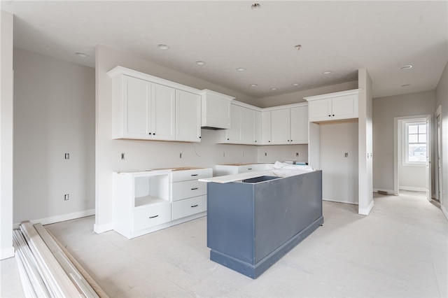 kitchen with a center island and white cabinets