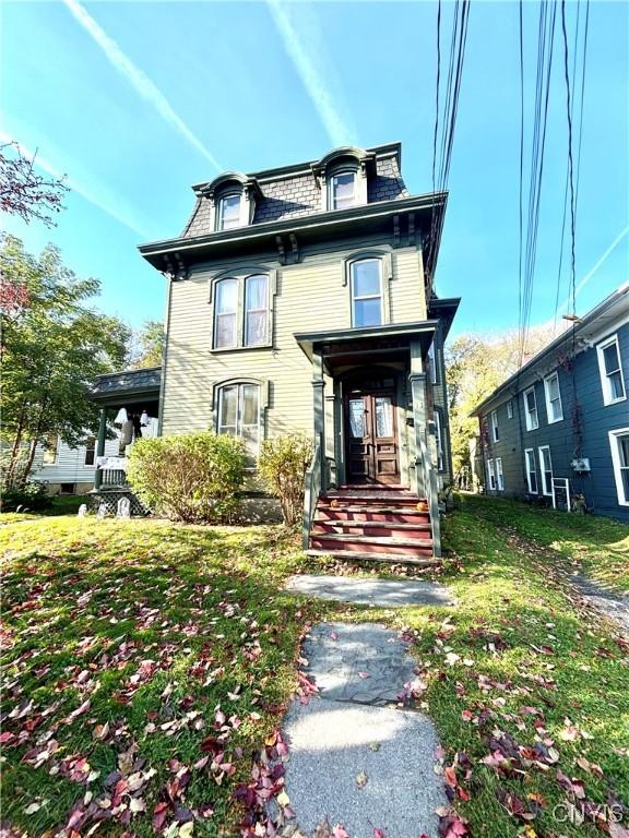 second empire-style home with mansard roof and a front lawn
