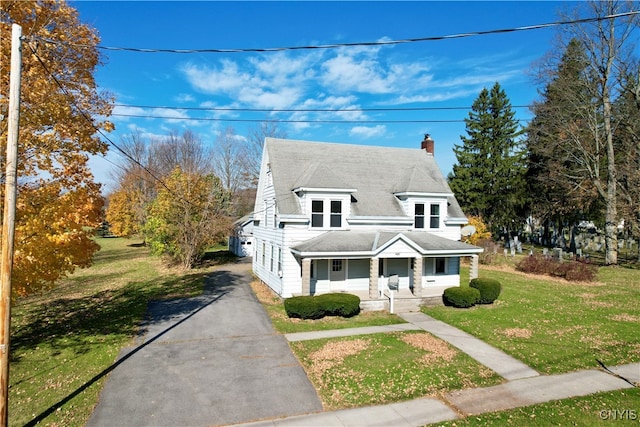 view of front of home featuring a front yard and a porch