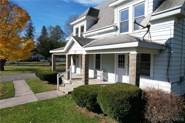 exterior space with a front yard and covered porch