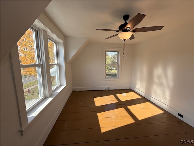 additional living space featuring dark hardwood / wood-style flooring, ceiling fan, and a wealth of natural light