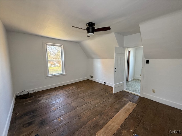 additional living space with vaulted ceiling, dark hardwood / wood-style floors, and ceiling fan