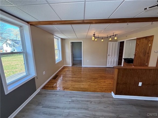 interior space featuring hardwood / wood-style flooring and a paneled ceiling