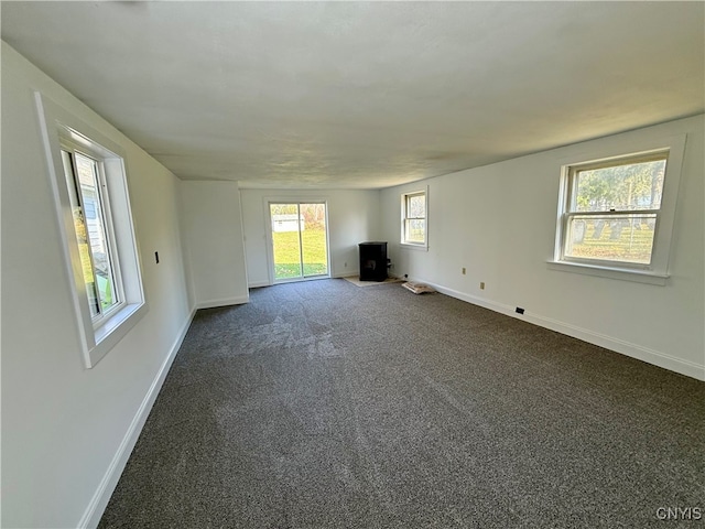 unfurnished living room featuring dark colored carpet