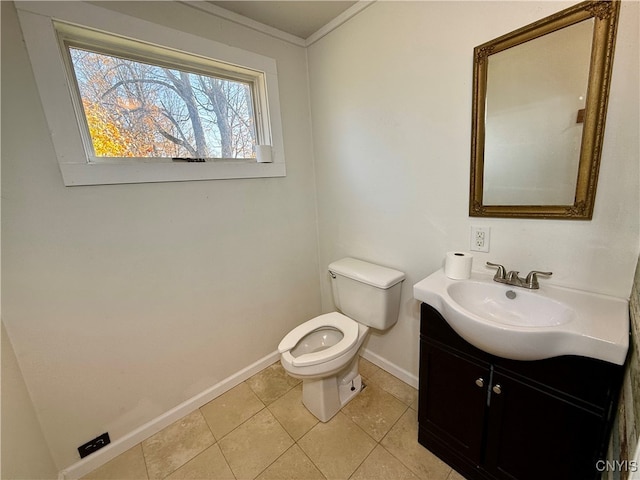 bathroom with vanity, toilet, crown molding, and tile patterned floors