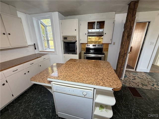 kitchen with range hood, backsplash, appliances with stainless steel finishes, and white cabinetry