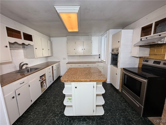 kitchen featuring sink, a kitchen island, appliances with stainless steel finishes, and white cabinetry