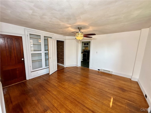 spare room with ceiling fan, hardwood / wood-style flooring, and a textured ceiling