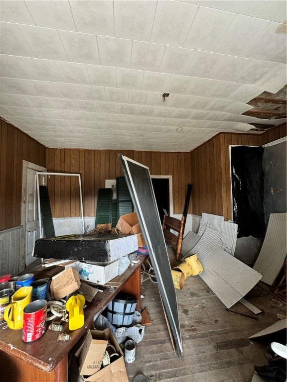 miscellaneous room with dark hardwood / wood-style floors and wood walls