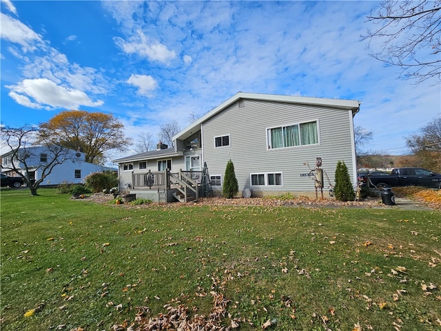 back of house featuring a yard and a deck