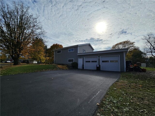 42 Pine Cir, Big Flats, NY 14845 - view of side of home with asphalt driveway and an attached garage