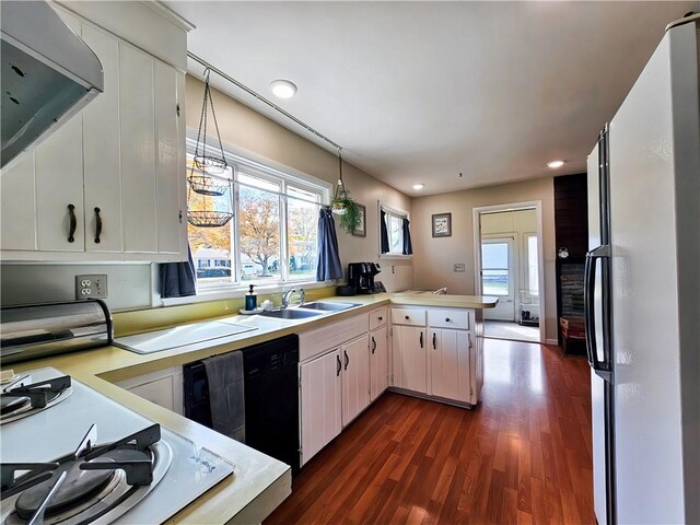 42 Pine Cir, Big Flats, NY 14845 - kitchen featuring white appliances, a peninsula, light countertops, a sink, and dark wood-style flooring