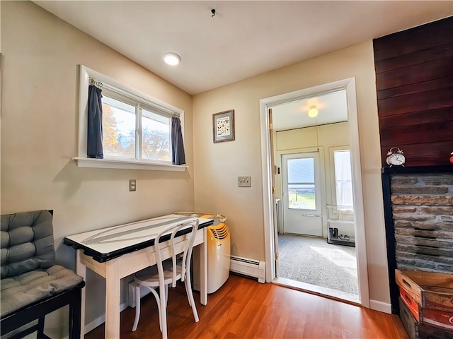 office area with a baseboard heating unit and hardwood / wood-style flooring