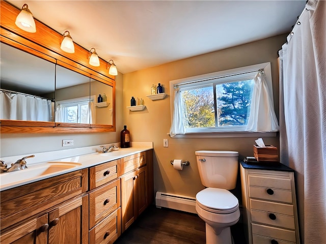 bathroom featuring toilet, hardwood / wood-style floors, vanity, and a baseboard radiator