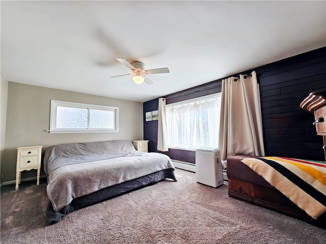 carpeted bedroom with ceiling fan and a baseboard radiator