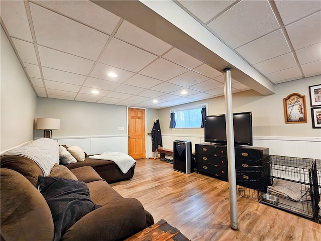 living room featuring hardwood / wood-style floors and a paneled ceiling