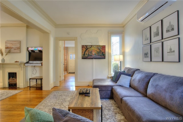 living room featuring ornamental molding, hardwood / wood-style floors, and a wall mounted AC