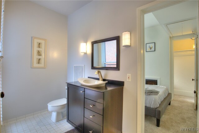 bathroom featuring vanity, toilet, and tile patterned floors