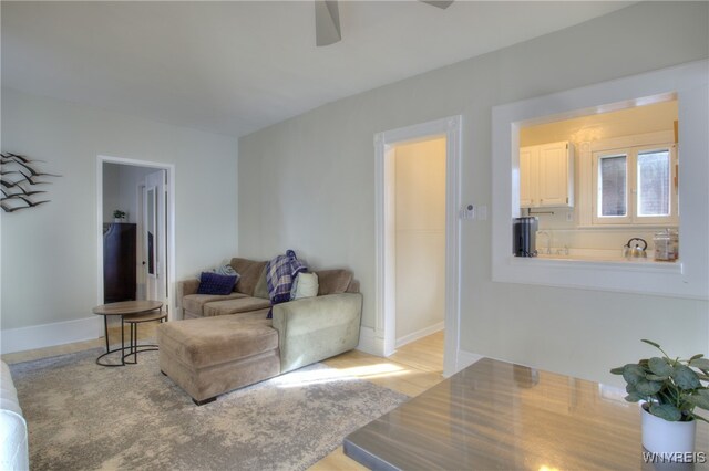 living room featuring ceiling fan and light wood-type flooring