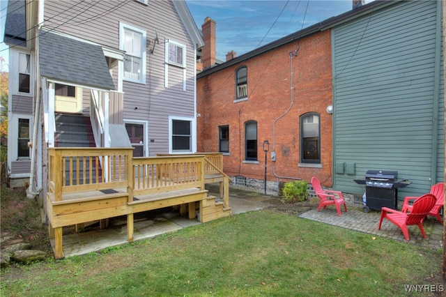 back of property featuring a patio, a lawn, and a wooden deck