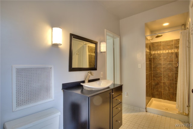 bathroom featuring vanity, curtained shower, toilet, and tile patterned flooring