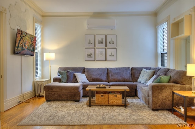 living room with a wall mounted air conditioner, crown molding, hardwood / wood-style flooring, and plenty of natural light