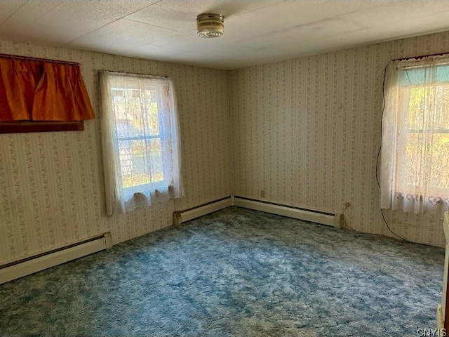 empty room with carpet, a textured ceiling, and baseboard heating