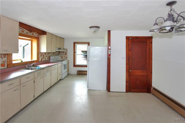 6736 Pine Grove Rd, Watson, NY 13343 - kitchen with white appliances, baseboard heating, under cabinet range hood, cream cabinets, and a chandelier