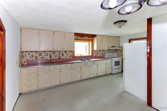 6736 Pine Grove Rd, Watson, NY 13343 - kitchen with white appliances, cream cabinetry, under cabinet range hood, and light flooring