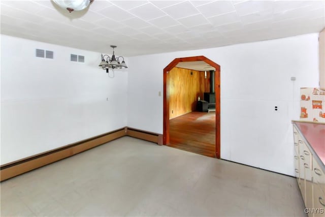 6736 Pine Grove Rd, Watson, NY 13343 - spare room with arched walkways, baseboard heating, a chandelier, and finished concrete floors