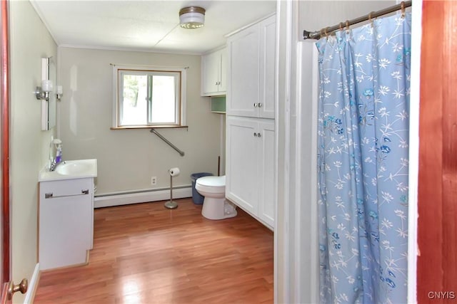 6736 Pine Grove Rd, Watson, NY 13343 - bathroom featuring baseboard heating, vanity, wood finished floors, and a shower with shower curtain