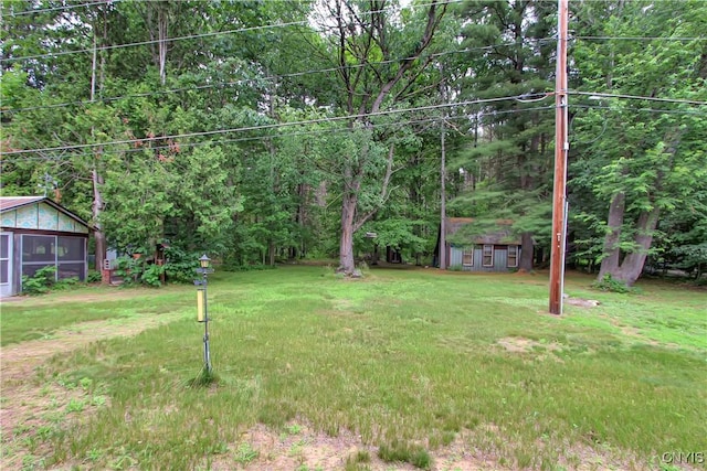 6736 Pine Grove Rd, Watson, NY 13343 - view of green lawn featuring a sunroom and an outdoor structure