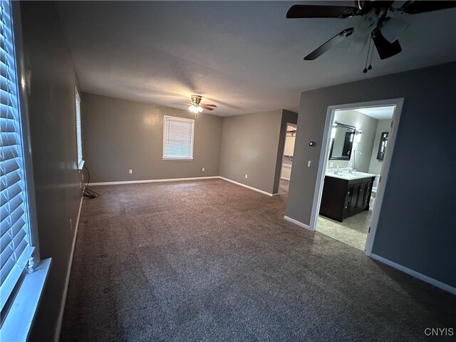 interior space with carpet and ceiling fan