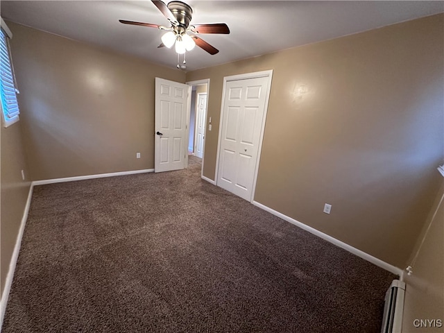 unfurnished bedroom featuring a closet, ceiling fan, carpet floors, and baseboard heating