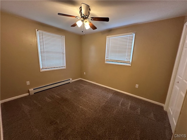 carpeted spare room featuring baseboard heating and ceiling fan