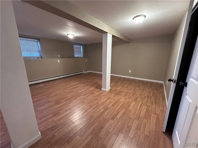 basement with wood-type flooring and a baseboard radiator