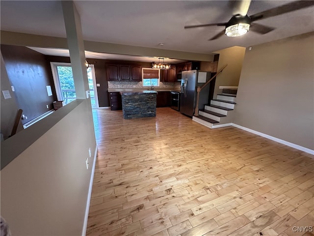 kitchen featuring tasteful backsplash, a baseboard radiator, stainless steel fridge with ice dispenser, light wood-type flooring, and a center island