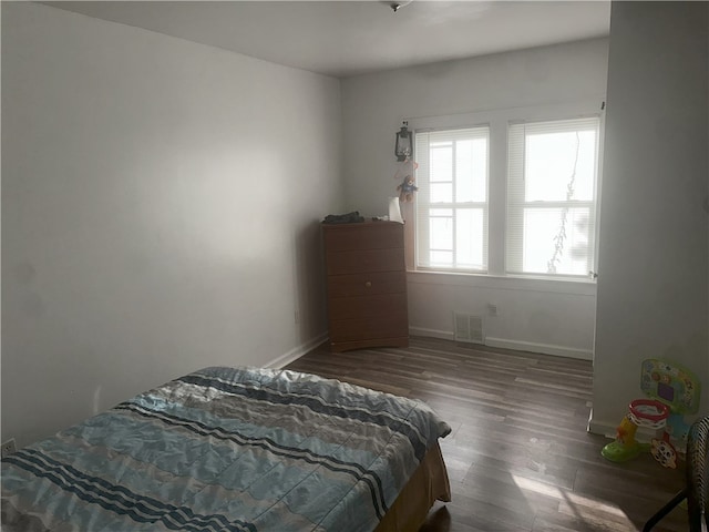 bedroom featuring dark wood-type flooring