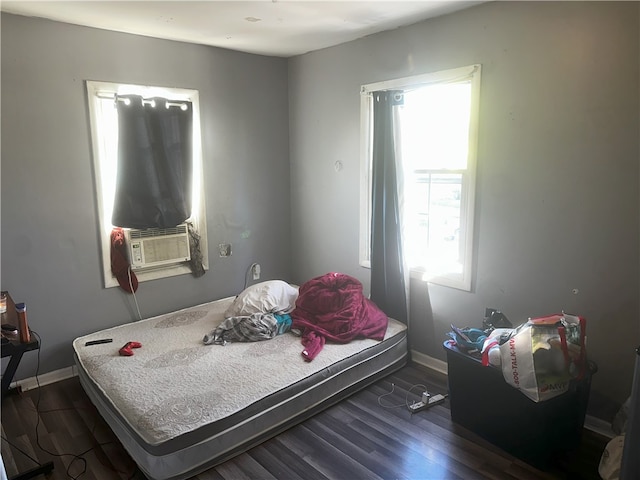 bedroom featuring dark hardwood / wood-style floors and cooling unit