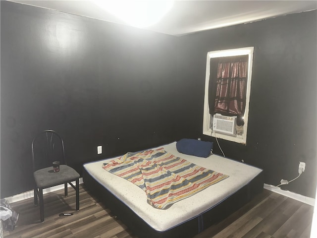 bedroom with cooling unit and dark wood-type flooring