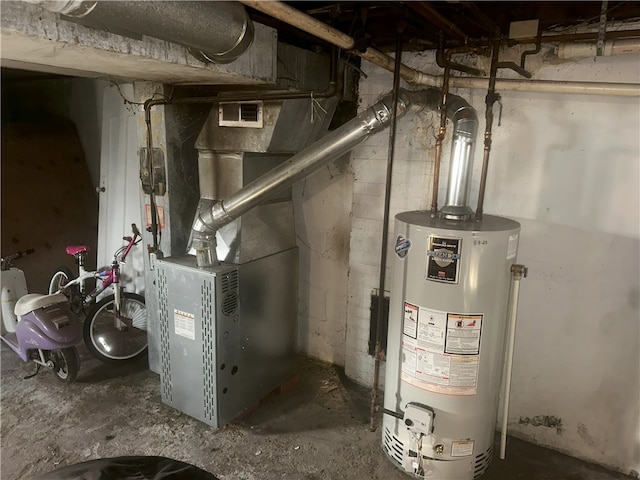 utility room featuring heating unit and water heater