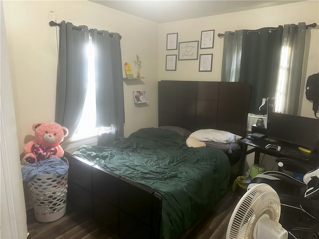 bedroom with dark wood-type flooring